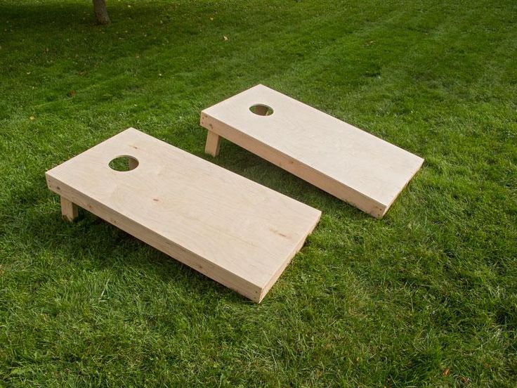 two wooden benches sitting on top of a lush green field