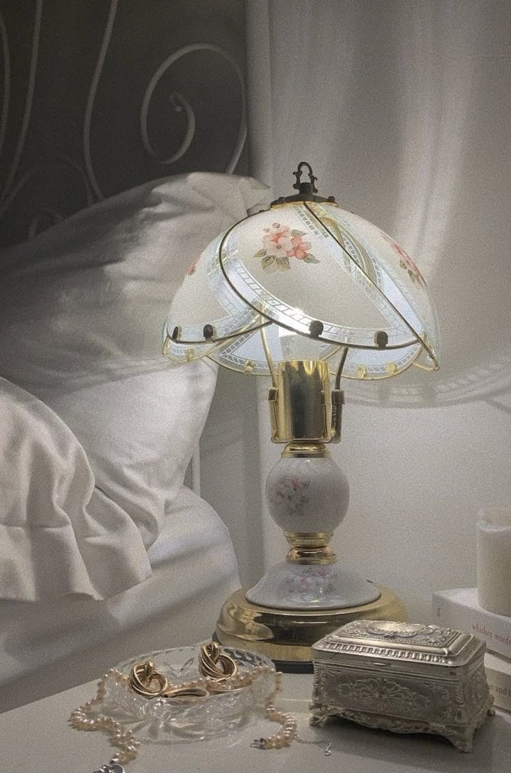 a lamp sitting on top of a table next to a bed