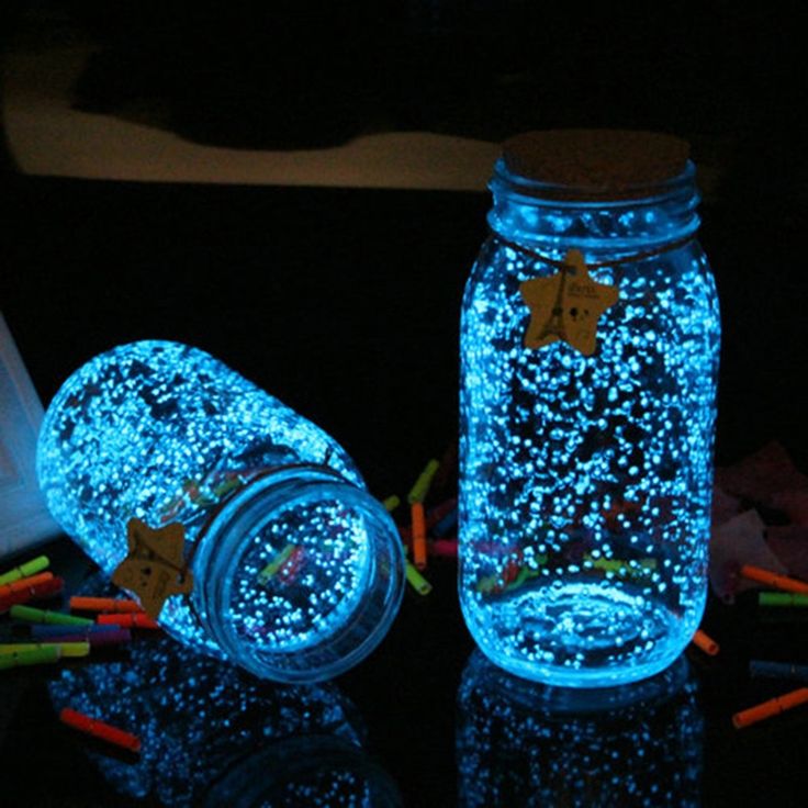 two mason jars with christmas lights in them