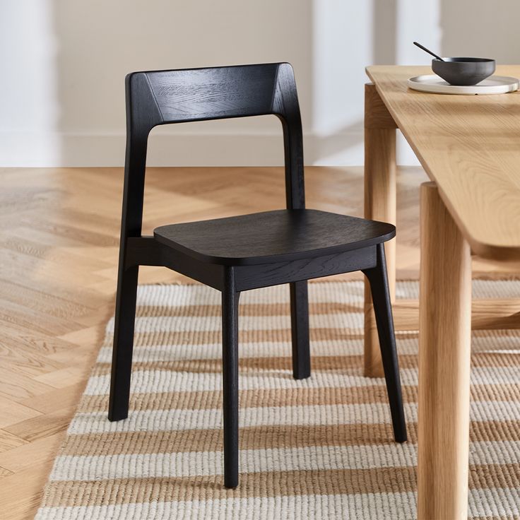 a black chair sitting on top of a wooden floor