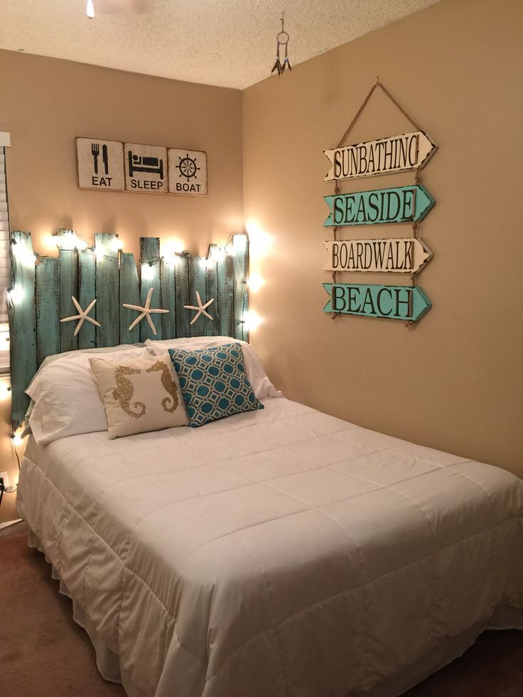 a white bed sitting in a bedroom under lights