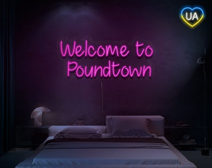 a neon sign that reads welcome to poundtown on the wall above a bed in a dark room