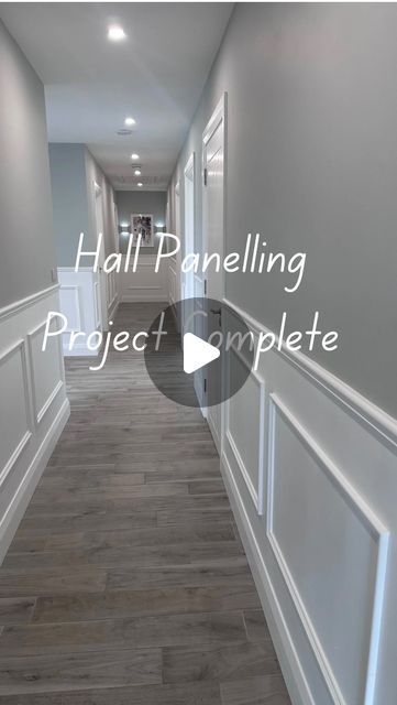 an empty hallway with white walls and wood flooring is featured in the video titled hall panelling project complete