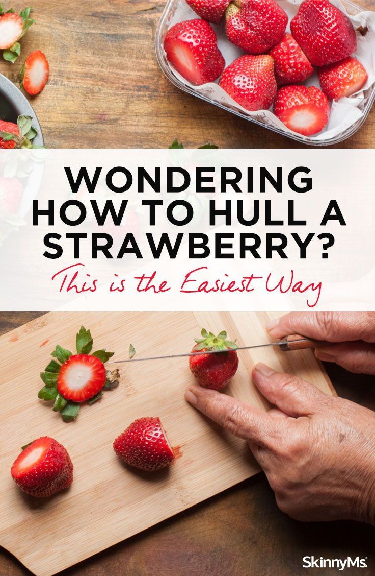 someone cutting strawberries with the words wondering how to hull a strawberry? this is the easy way