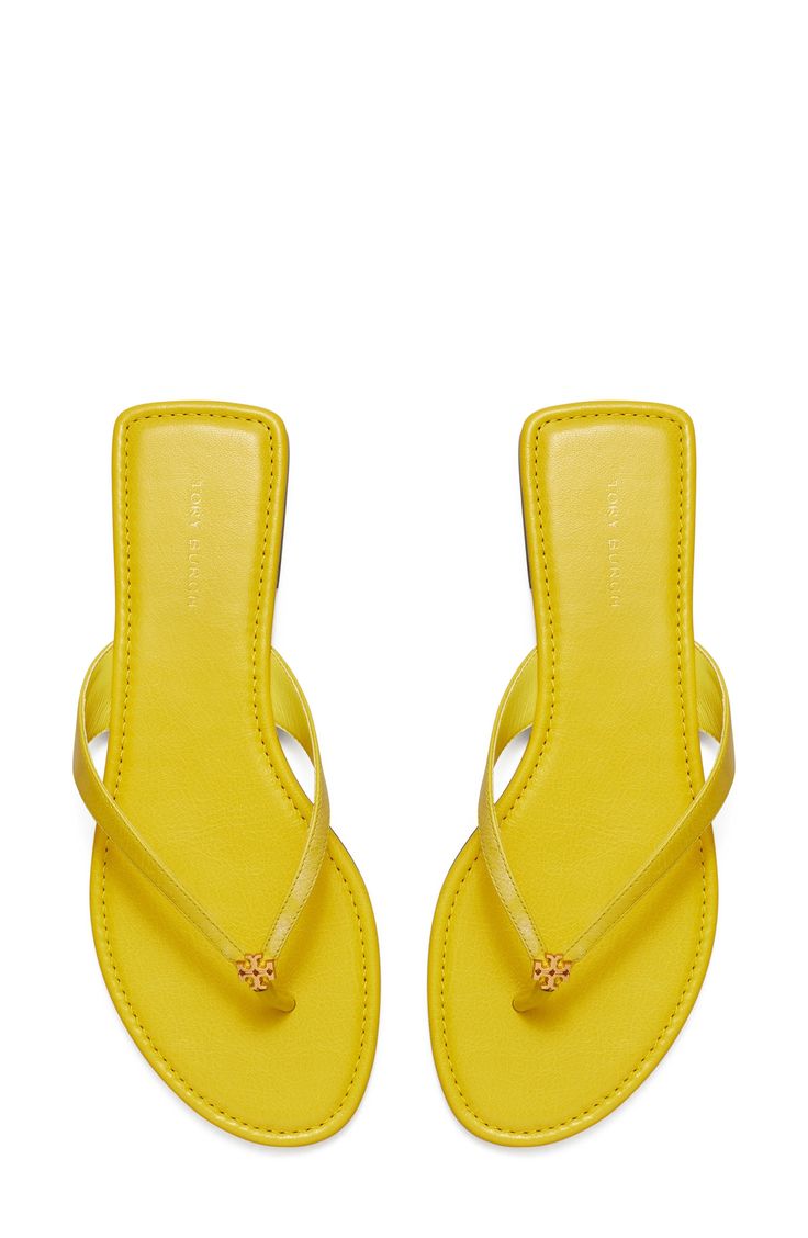 Signature logo hardware details the toe post of a versatile flip flop that will complement your warm-weather style. Flat sole Leather or synthetic upper/leather lining and sole Imported Trendy Yellow Flat Flip Flops, Brown Flat-heel Summer Flip Flops, Summer Vacation Sand-colored Flip Flops, Yellow Tory Burch Sandals, Tory Burch Flip Flops, Yellow Sandals, Cute Shoes Heels, Trendy Fits, Leather Flip Flops