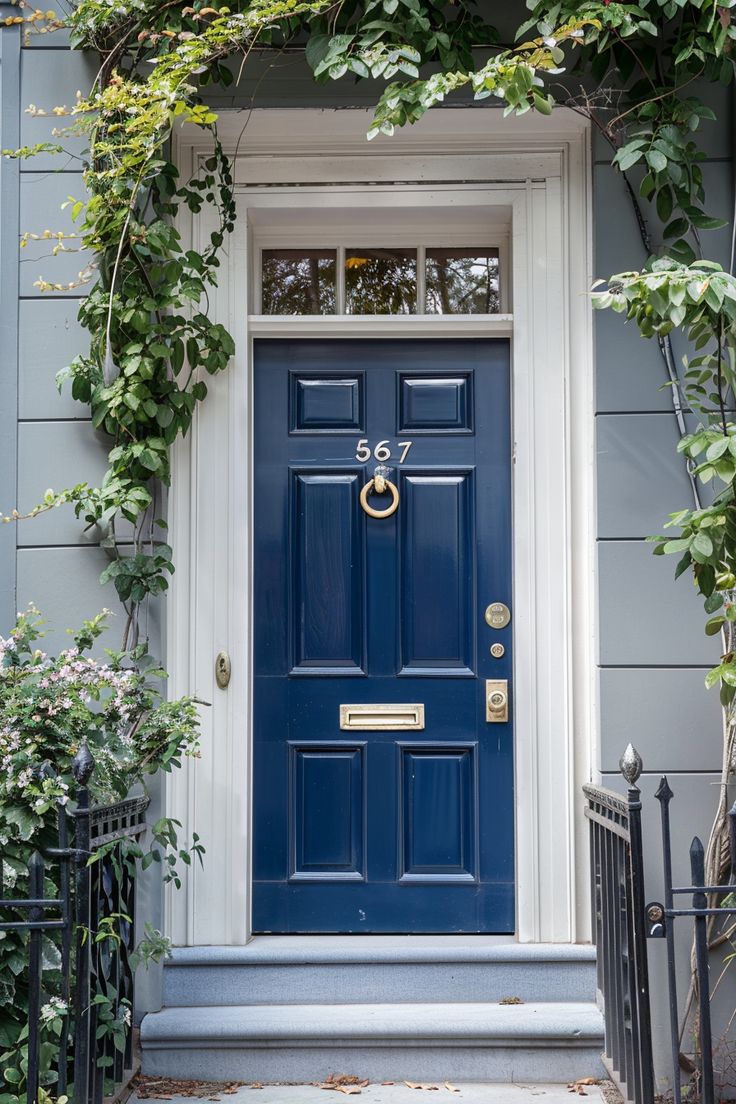 a blue front door surrounded by greenery