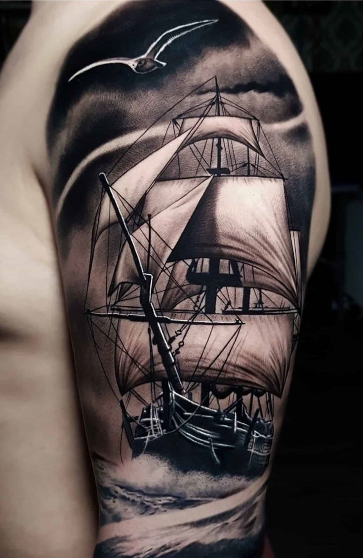 a man's arm with a ship on it