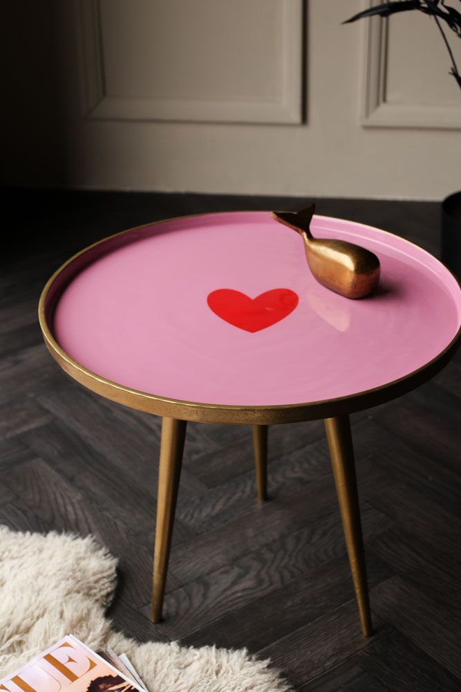 a pink table with a red heart painted on it