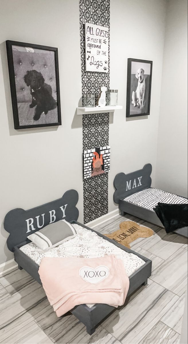 two beds in a room with pictures on the wall