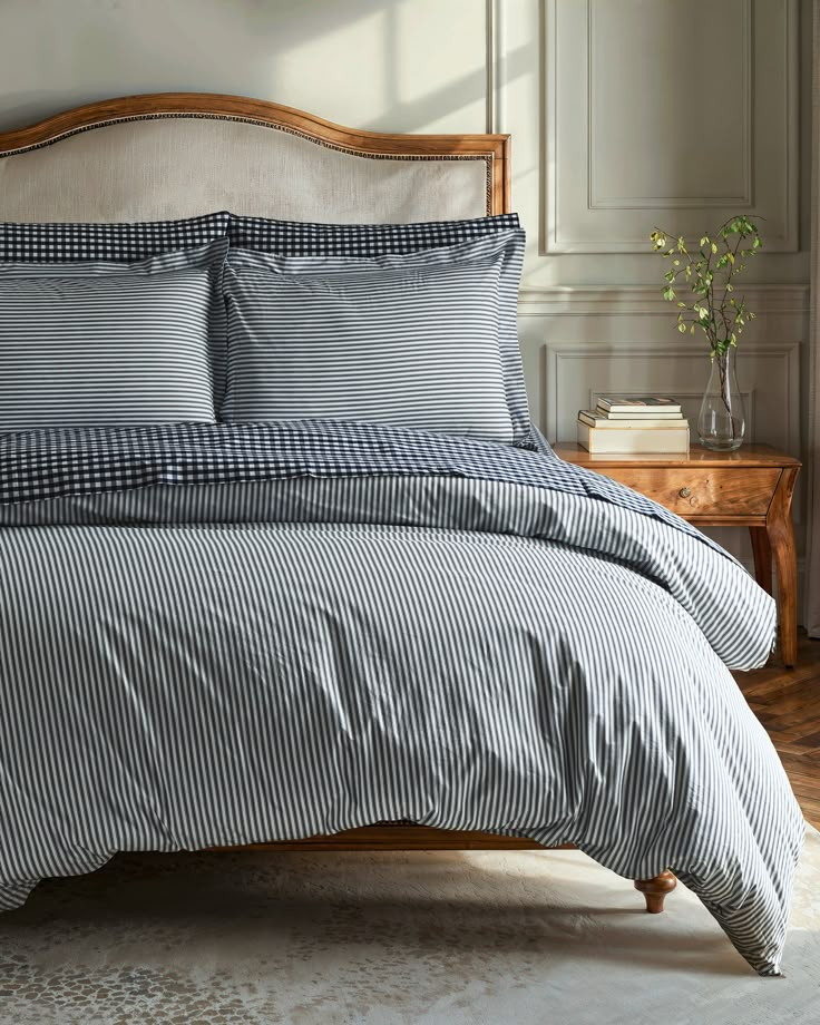 a bed with blue and white striped sheets