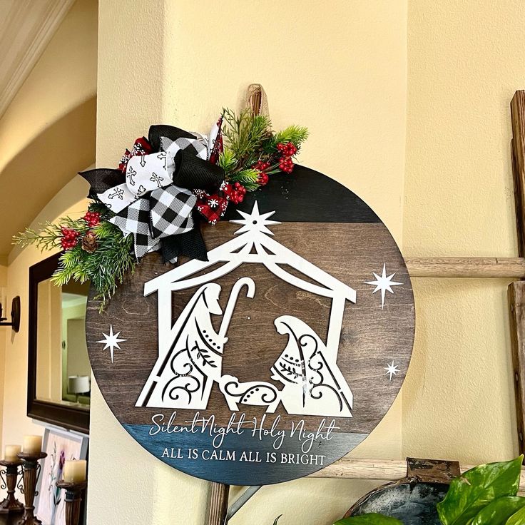 a wooden sign with a nativity scene on it