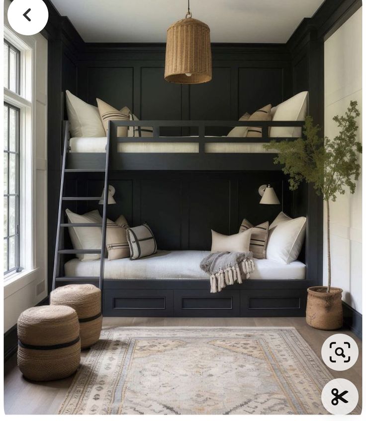 a bunk bed in a room with black walls and white pillows on the bottom bunk