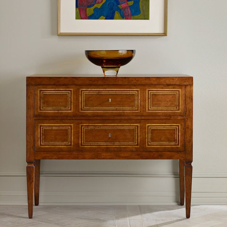 an old dresser with a bowl on top