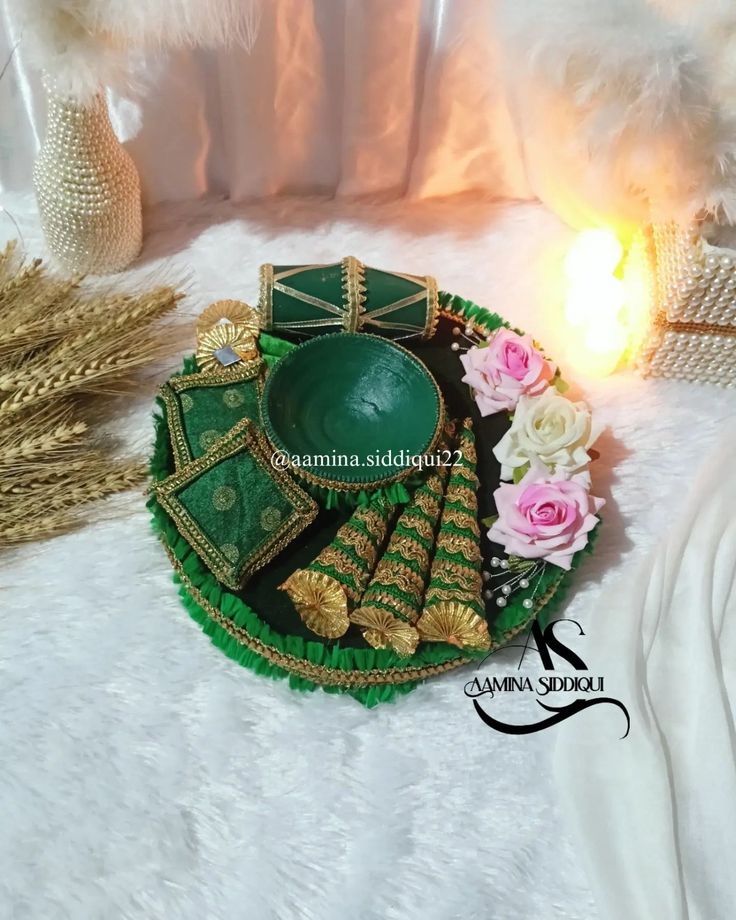 green and gold plate with flowers on white furnishing next to decorative items for diwaling