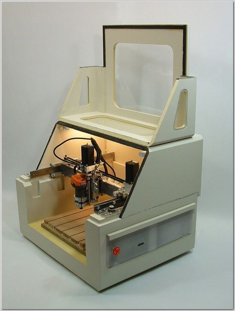 a machine that is sitting on top of a white surface with light coming from it