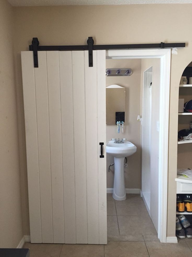 an open door leading to a bathroom with a sink