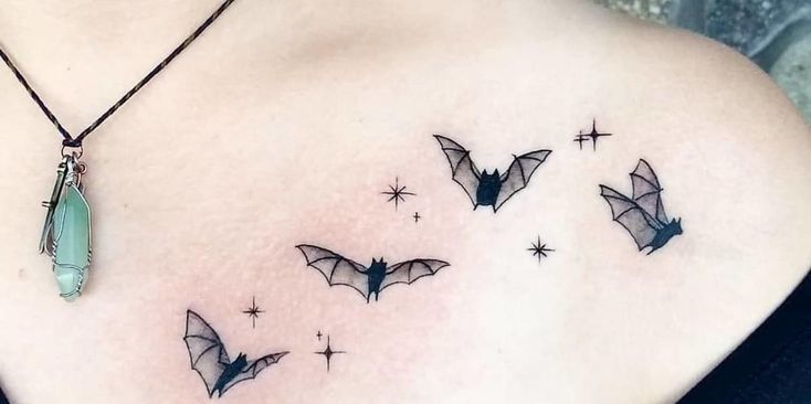 a woman's chest with some bats and stars on it