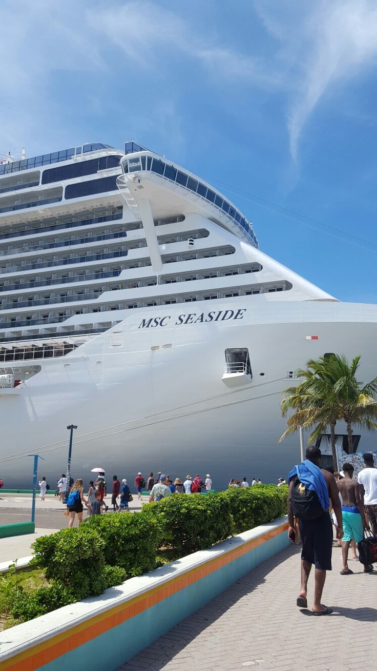 people are walking around in front of a cruise ship