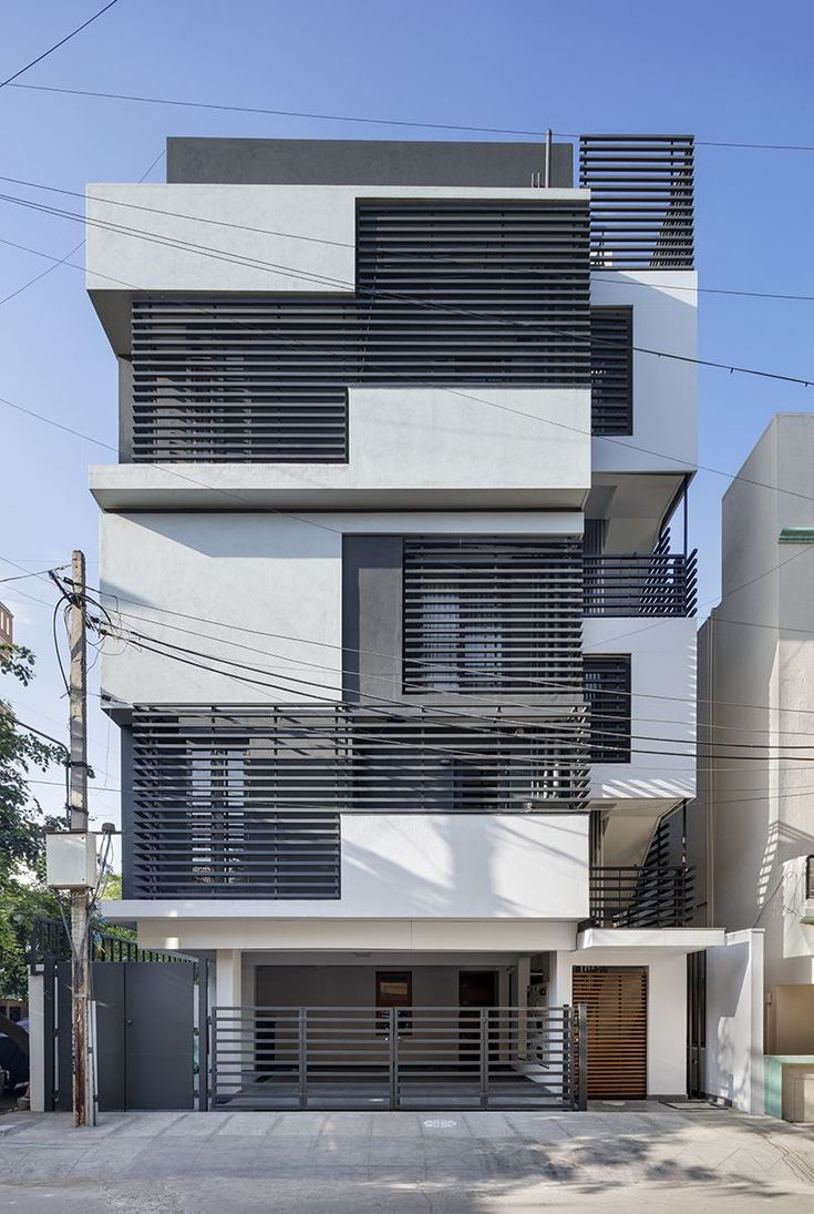 an apartment building with multiple balconies on the second floor