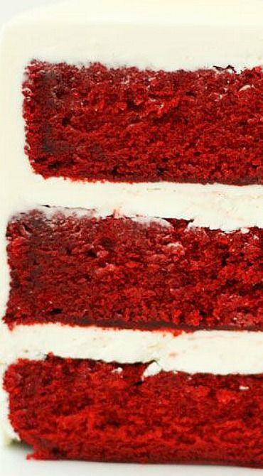 a slice of red velvet cake with white frosting