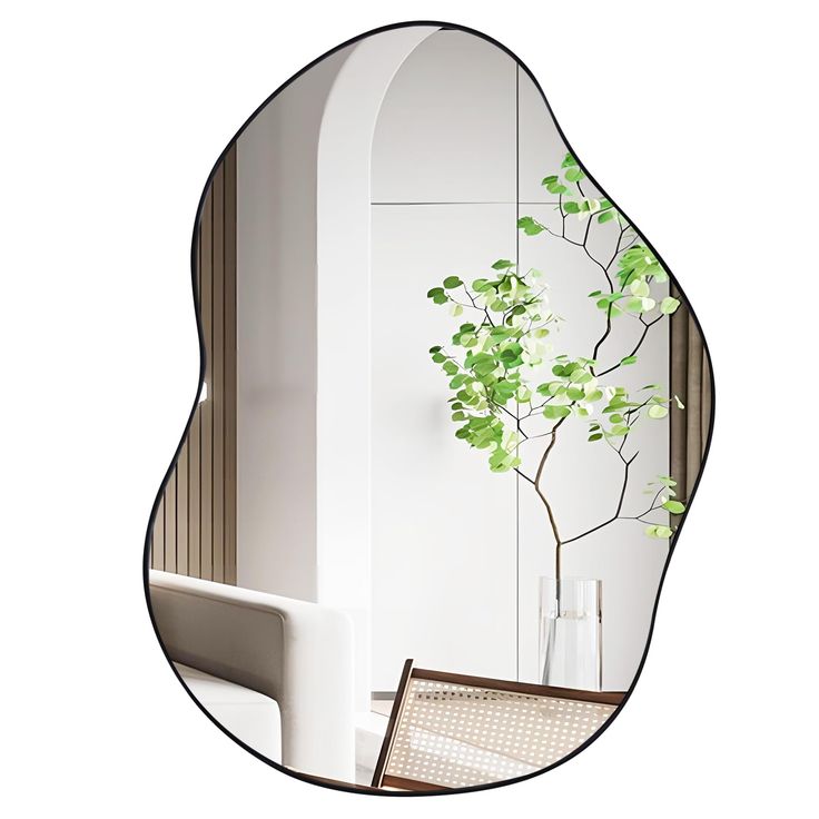 a mirror reflecting a plant in a vase on a table next to a chair and window