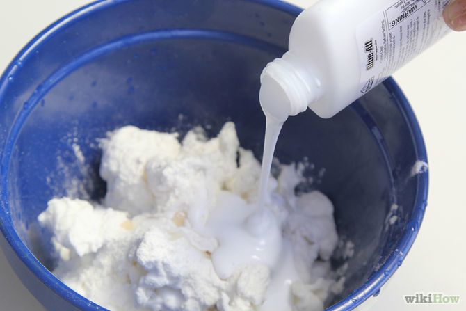 a person pouring milk into a blue bowl filled with white sugar and ice cubes