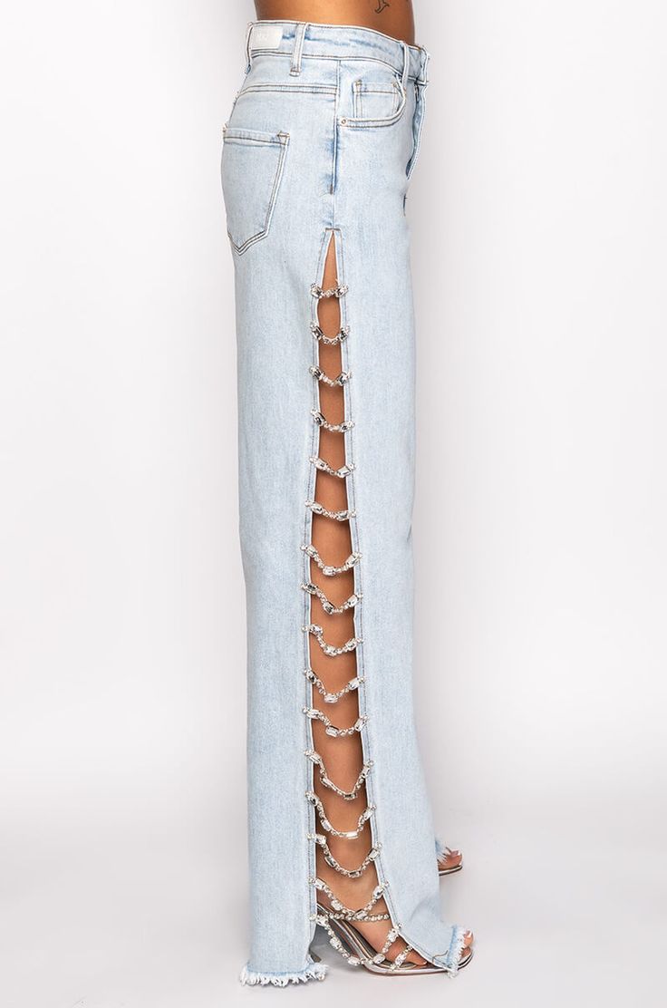 The akira label covered in diamonds relaxed jeans are made from a washed denim fabrication and feature a high rise waist, belt loops, a classic five-pocket design, relaxed pant legs, long, sexy side slits with rhinestone gem link detailing, fringe hems, and a button and zipper closure.  - 99% cotton 1% spandex- minimal stretch(all measurements approximate from size 3)- 31.5” inseam- 10.5” rise- 33” side slits- model height is 5'7"- model height is 5'8.5"- importedproduct id: Chic Denim Pants With Belt Loops, Edgy High Rise Medium Wash Jeans, Edgy Light Wash Denim Jeans, Edgy High Rise Medium Wash Flare Jeans, Trendy Medium Wash Jeans With Belt Loops, Edgy High Rise Flare Jeans In Medium Wash, Chic Jeans With Belt Loops In Rigid Denim, High-rise Cropped Jeans With Belt Loops, Edgy Light Wash Straight Leg Bottoms