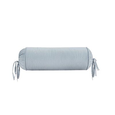 an image of a pillow with tassels on the back and one side rolled up