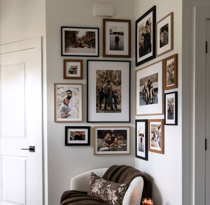 a living room filled with lots of pictures on the wall