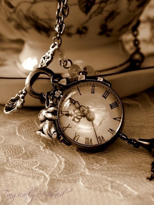 an antique pocket watch with chain attached to it