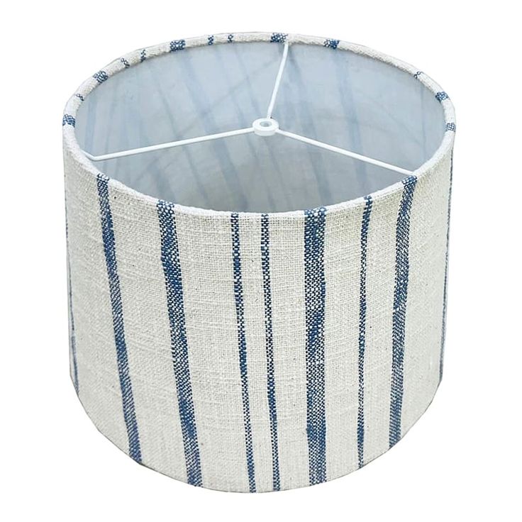 a blue and white striped lamp shade on a white background, with the fabric lining