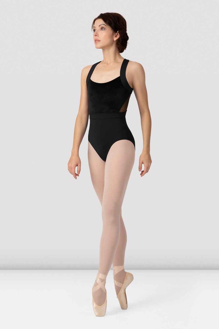 a woman in a black leotard and ballet shoes