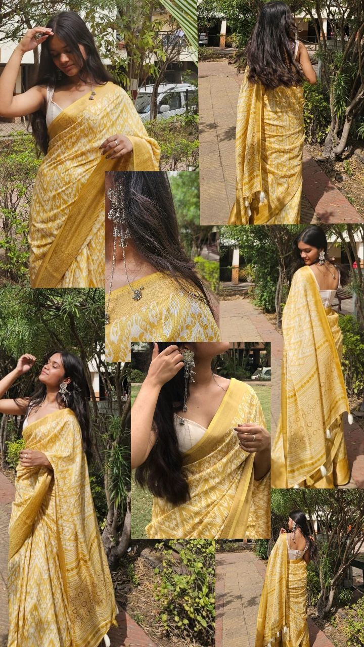 the woman is wearing a yellow sari