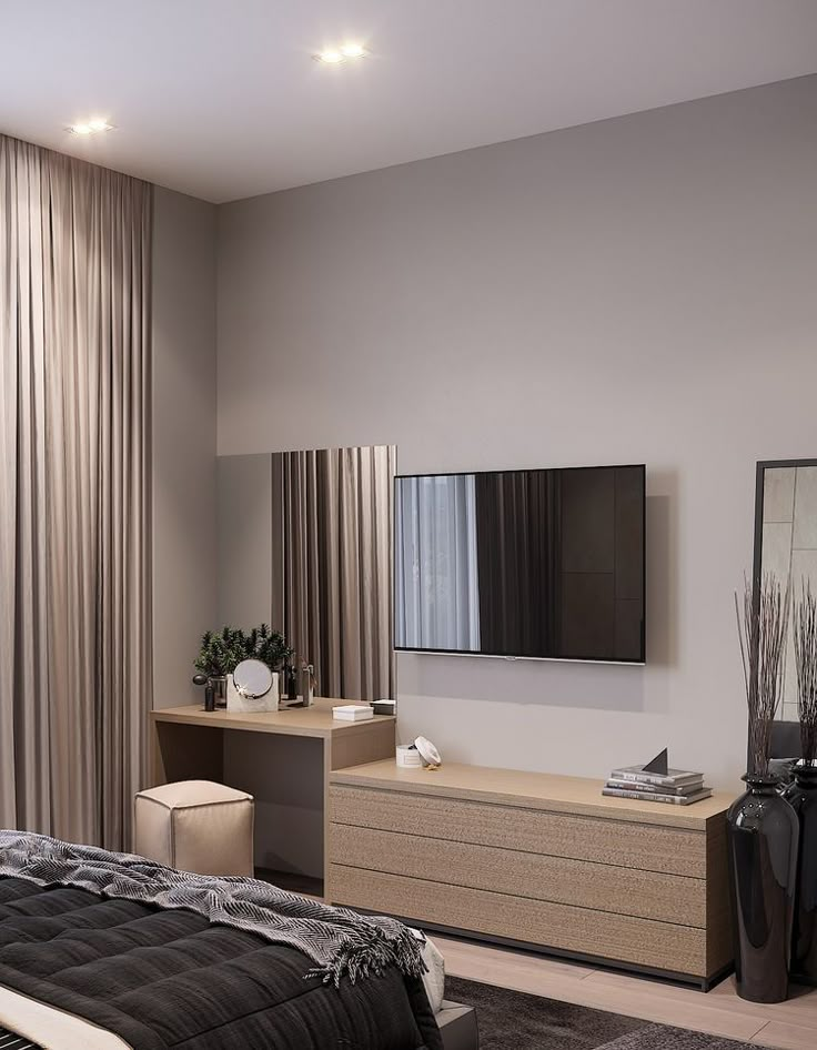 a bedroom with a large flat screen tv mounted on the wall