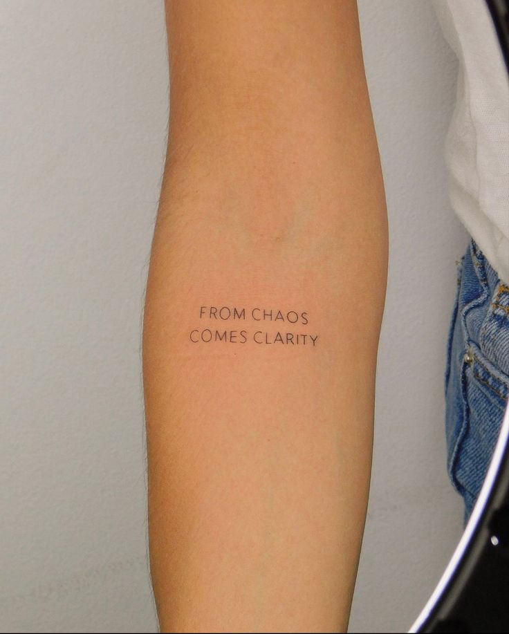 a person's arm with the words from chaos comes charity written on it in black ink