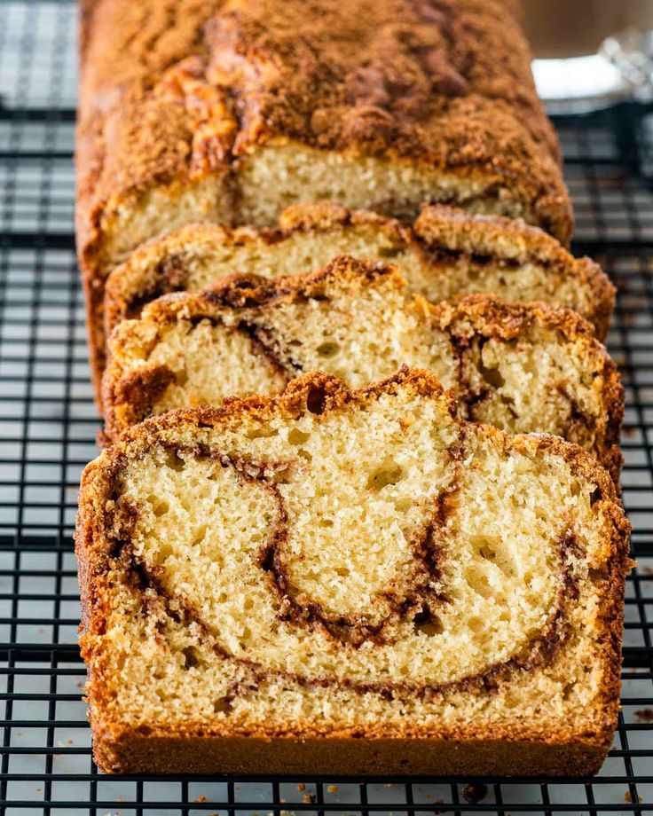 a loaf of cinnamon swirl bread on a cooling rack