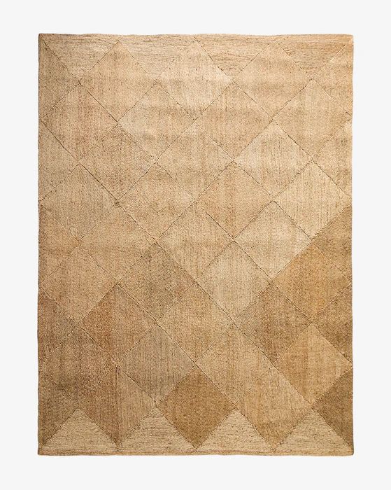 a beige rug with an abstract design on the top and bottom corner, in two different colors