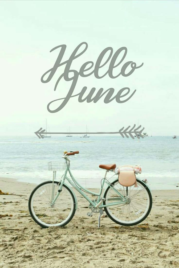 a bicycle is parked on the beach near the water