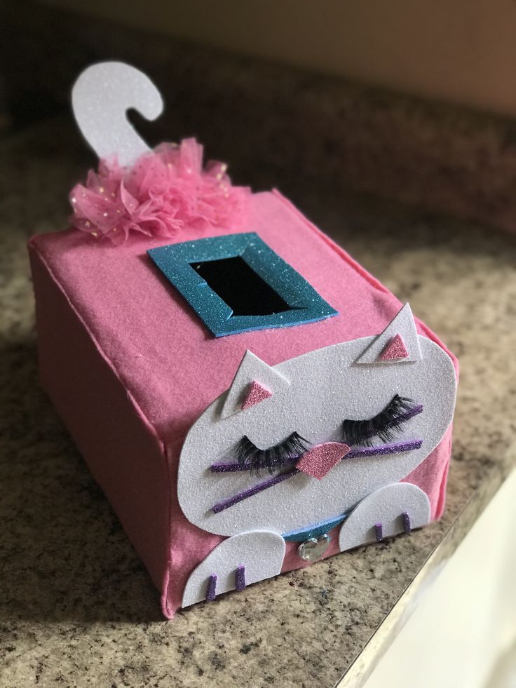 a pink box with a white cat on it's face and the number two