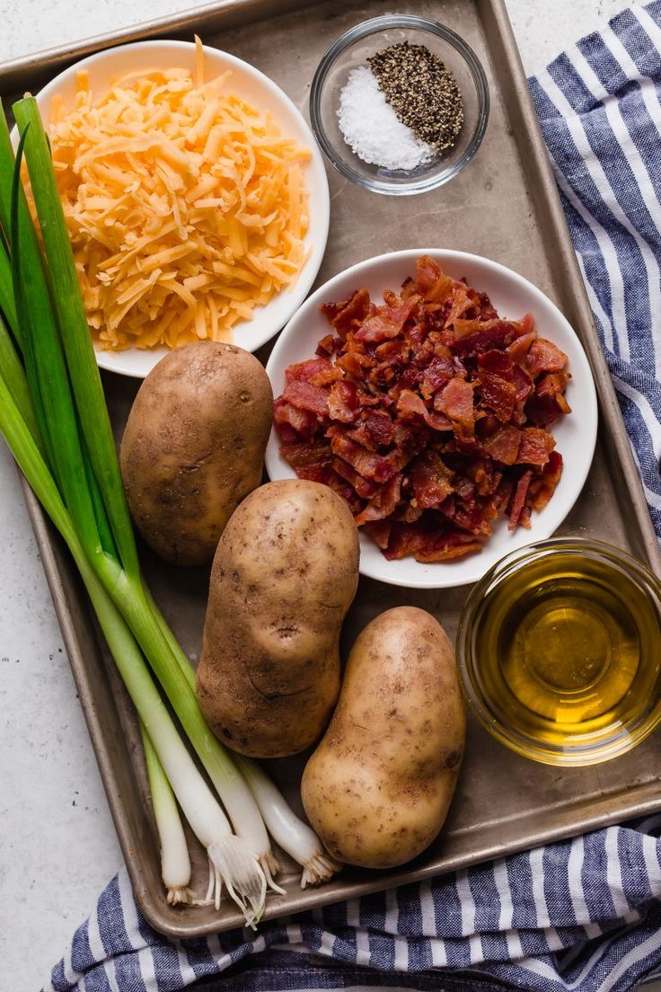 potatoes, cheese and other ingredients on a tray