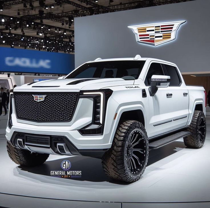 a white truck is on display at an auto show