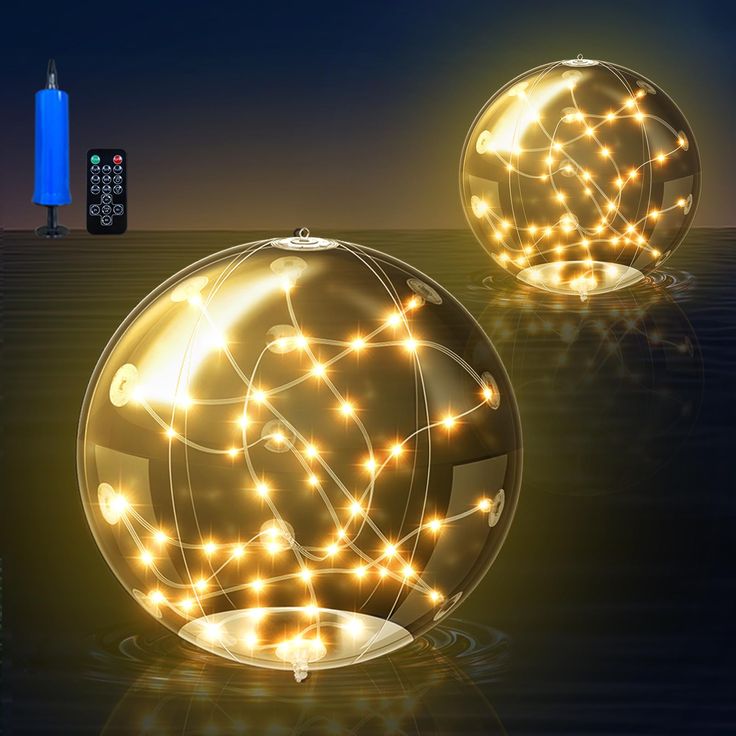 two lighted balls sitting next to each other