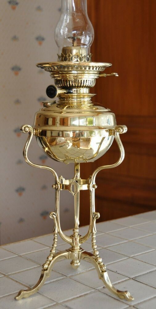 an old fashioned brass oil lamp on a table