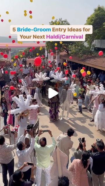 a group of people standing around each other in front of a crowd with red and yellow balloons