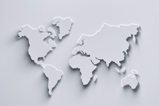 the world map is cut out of paper and placed on a gray surface with white background