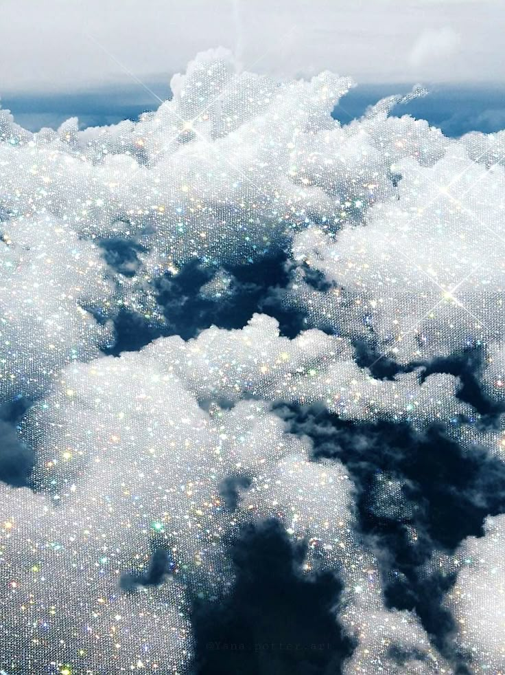 the sky is filled with lots of white fluffy clouds and sparkling sparkles on them