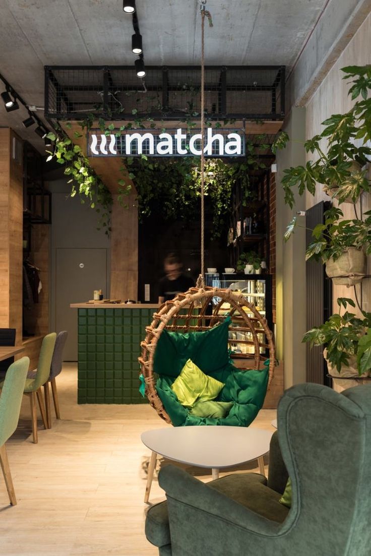 the interior of a restaurant with green furniture