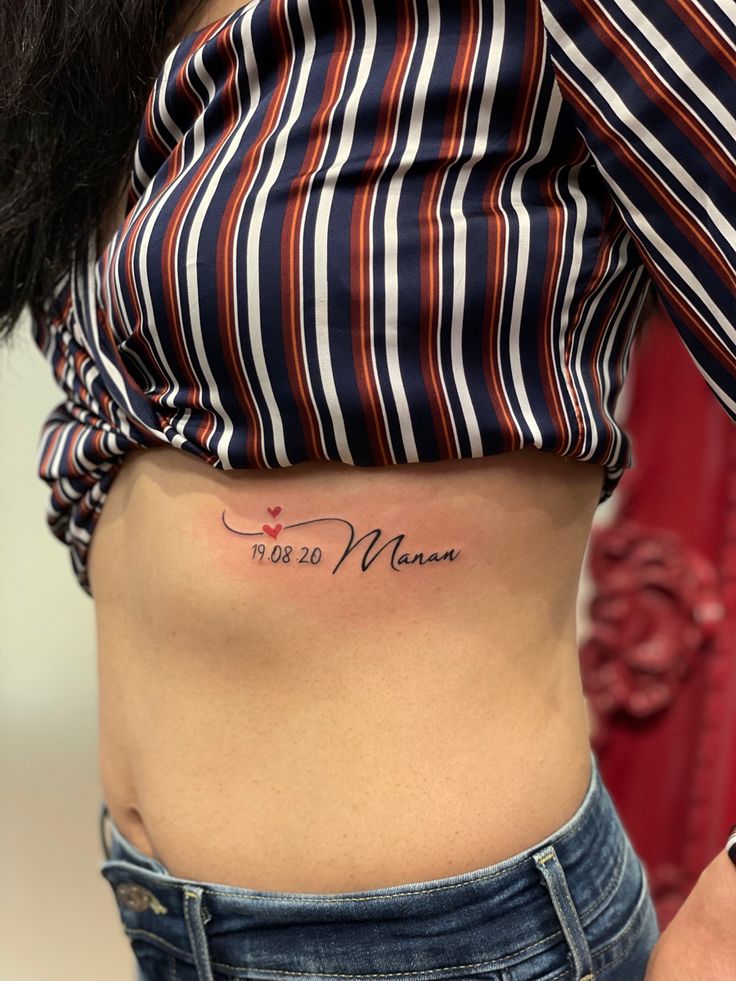 a woman with a small tattoo on her stomach that says, i love you mom