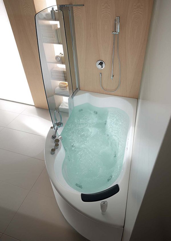 a bathroom with a tub and shower head mounted to the side of the bathtub