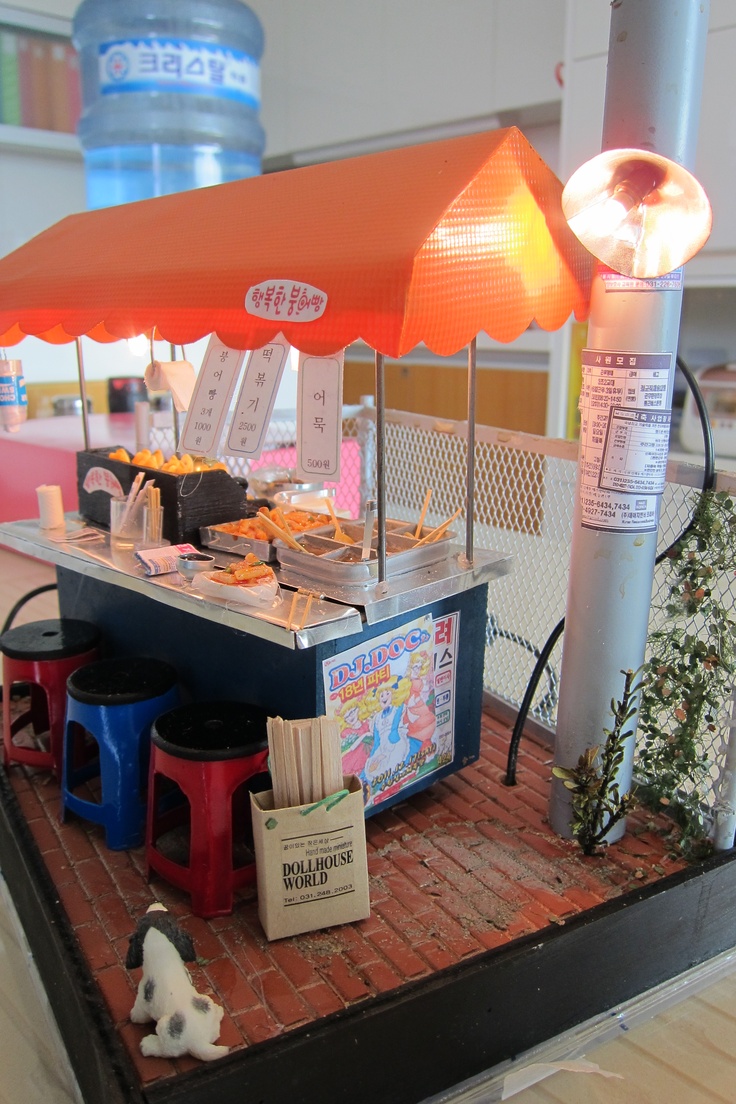 a small food stand with an umbrella over it